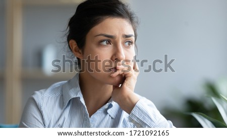 Head shot close up sad young indian woman thinking of problems, looking away. Unhappy millennial hindu girl student suffering from personal professional troubles, feeling depressed at home. Royalty-Free Stock Photo #1721092165