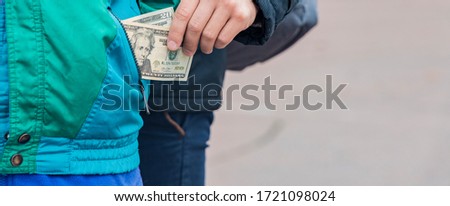 crime steal money from pocket robber thief action finance crisis time on the street concept poster picture with neutral unfocused background and empty copy space for your text here 