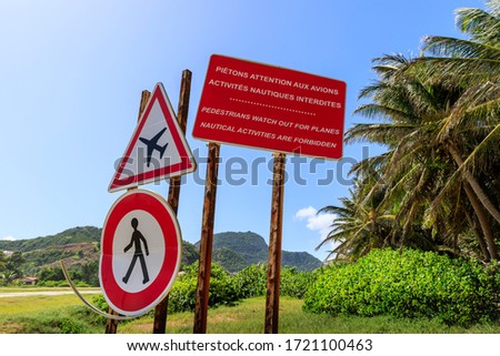 Airport runway red warning signs in a tropical setting on Terre-de-Haut island in Iles des Saintes Guadeloupe