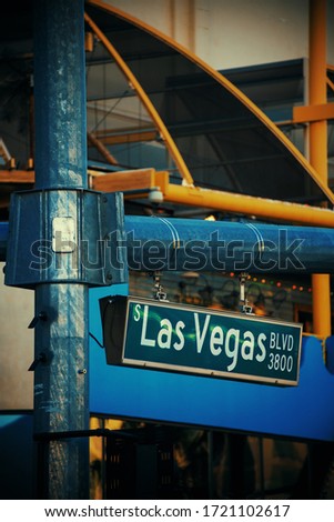 Las Vegas road sign with modern casino hotel and resort architecture in Strip.