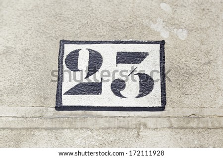Number twenty on a wall, detail of figures on the wall of a house number information