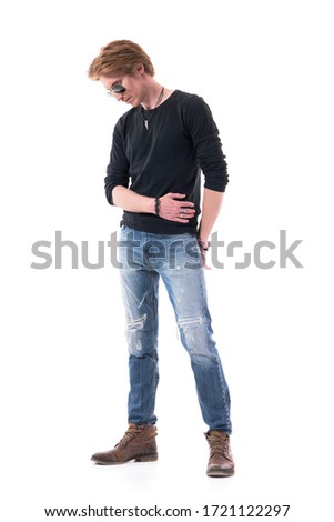 Disappointed young handsome redhead man fashion model looking down pensive. Full body isolated on white background. 