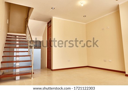 Wood floating stair steps on empty living room