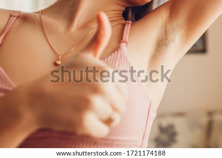 Hairy unshaven female armpits. Body positive trend. Woman wearing bra raised arms. Acceptance of body naturalness