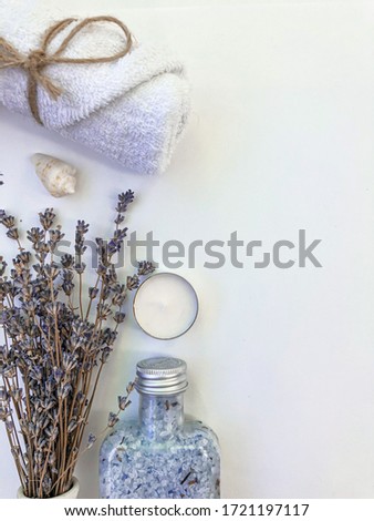 Spa wellness decorations blue and violet items top view on white background with lavender, towel candle and seashells
