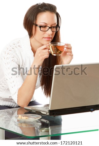 A business woman is drinking tea at the desk - on white background