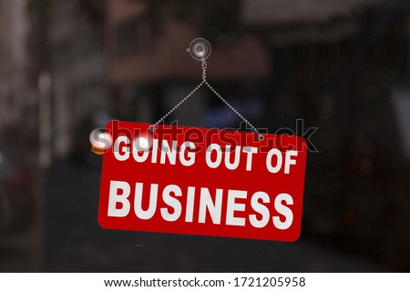 Close-up on a red closed sign in the window of a shop displaying the message "Going out of business". Royalty-Free Stock Photo #1721205958
