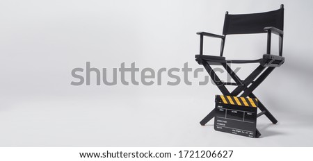 Director chair and Clapper board or movie slate. It's black with yellow color on white background. Royalty-Free Stock Photo #1721206627