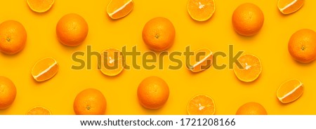 Fresh juicy whole and sliced orange on bright yellow background. Fruit pattern, creative summer concept. Flat lay Top view. Minimalistic background with citrus fruits, vitamin C. Pop art design Banner Royalty-Free Stock Photo #1721208166