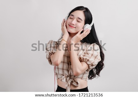 young woman isolated on white background wearing headphones Close your eyes to listen to music