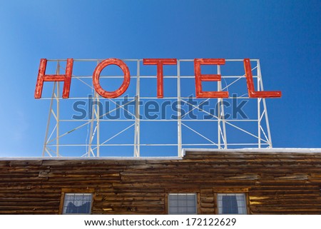 Vintage hotel sign above an old wooden cabin in the Colorado Rocky Mountains