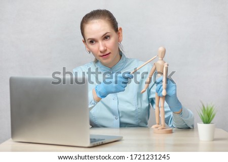 An orthopedic doctor conducts online training on a laptop. Close up.
