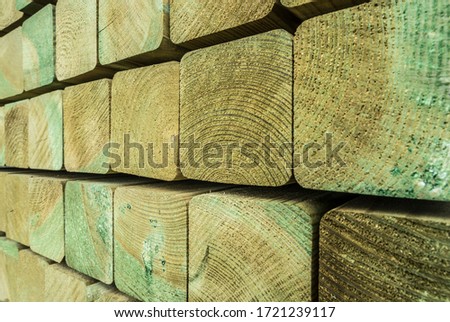 stack of green impregnated construction wood Royalty-Free Stock Photo #1721239117