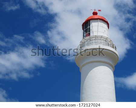 Red and White Lighthouse Against Sky