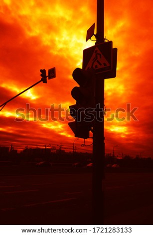 Traffic lights during dramatic sunset background