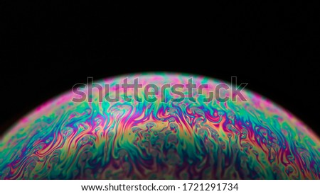 Colorful macro shot of a bubble, looking like a small planet