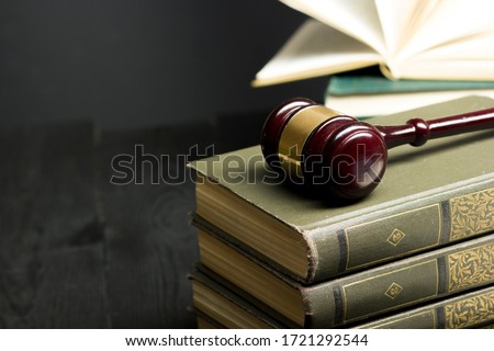 Law concept - Open law book with a wooden judges gavel on table in a courtroom or law enforcement office isolated on white background. Copy space for text Royalty-Free Stock Photo #1721292544