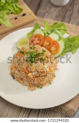Fried rice with egg and grilled salmon on the white plate -Stock photo