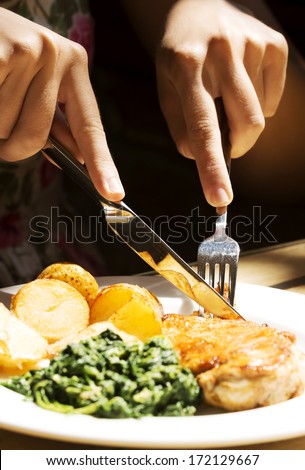 Picture of palte and food cut with cuterly. In a restaurant.