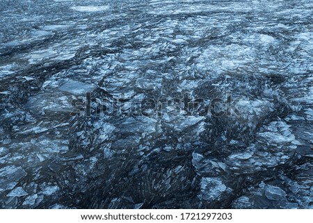 Spring ice flow on the north lake. Water view from above.