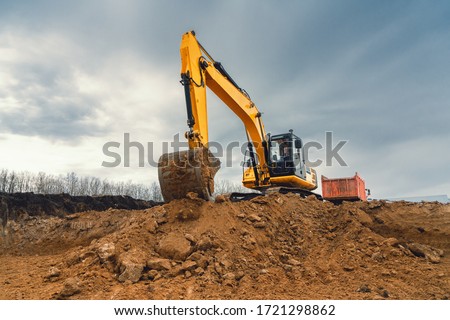 A large construction excavator of yellow color on the construction site in a quarry for quarrying. Industrial image. Royalty-Free Stock Photo #1721298862
