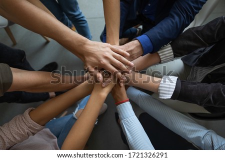 Close up mixed race business people putting hands together, support and unity concept. Diverse colleagues joining in team building activity, staff training concept, start working together, teamwork. Royalty-Free Stock Photo #1721326291