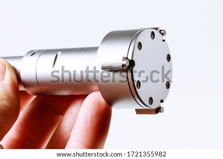 Mechanical Three-Point Internal Micrometer in hand on a white background.