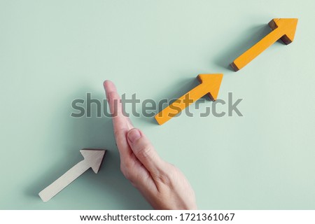 Hand blocking the growth arrows, managing impacts of Covid-19 GDP growth disruption, global economy supply chain crisis business concept Royalty-Free Stock Photo #1721361067
