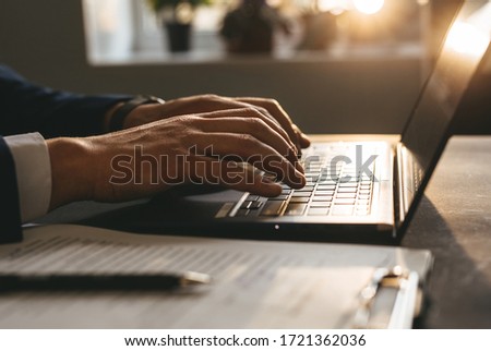 Hands of Businessman working on laptop.