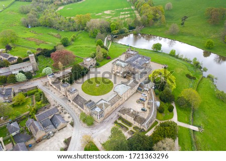 Aerial photo of the small village of Ripley in Harrogate, North Yorkshire in the UK showing the historical British Ripley Castle Wedding Venue along side the Ripley Lake