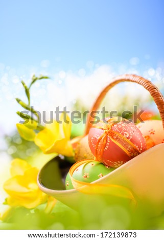 Easter background with eggs and spring flowers, shallow DOF, text space