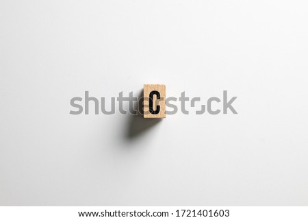" C  " text made of wooden cube on  White background with clipping path.