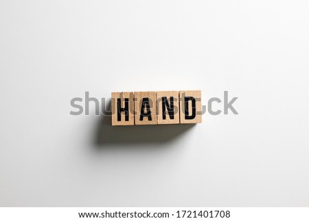 " hand " text made of wooden cube on  White background.
