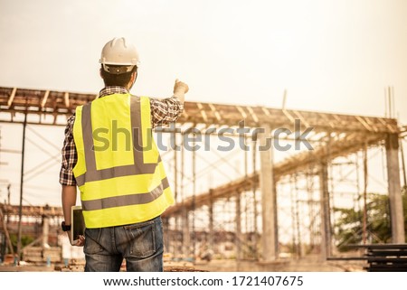 Engineer working on building site.