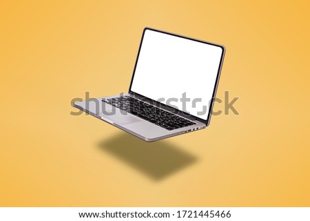 Laptop computer with blank screen isolated on yellow background