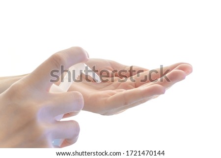 Woman hand using alcohol hand sanitizer gel on white for hand hygiene.