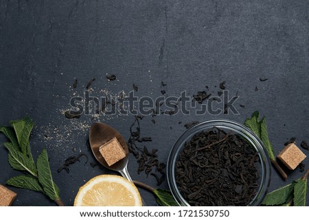 tea with mint and lemon on a dark background