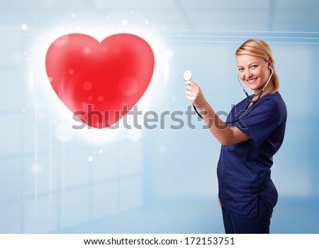 Pretty young nurse healing a red heart
