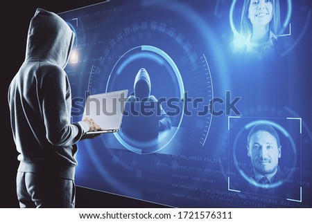 Hacker using laptop with people recognition system. Global business interface and stock chart. Business and media concept.