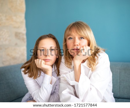 Mother and daughter sitting on the sofa Royalty-Free Stock Photo #1721577844