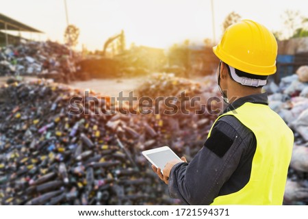 Foreman controls the recycle waste separation of recyclable waste plants. Waste plastic bottles and other types of plastic waste. Royalty-Free Stock Photo #1721594371