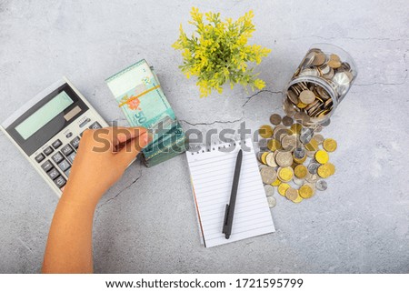 Female hand calculate Malaysia Bank notes. Financial concept, Accounting Concept.
