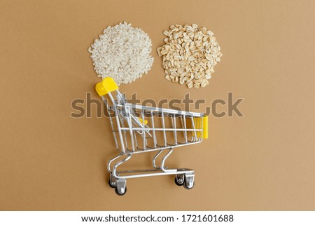 various groats in a grocery cart on a brown background. Rice and oatmeal