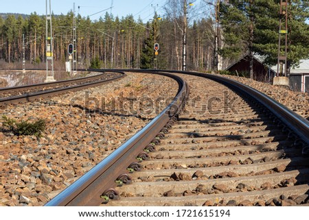 Double railway track in a curve where the outer track is performed for high speed train with change in elevation (height) between the two rails or edges, picture from Mellansel Vasternorrland Sweden.