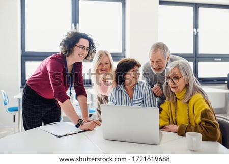 Group of senior people attending computer and technology education class. Royalty-Free Stock Photo #1721619688