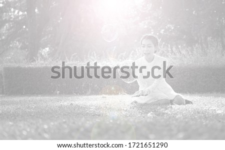 Asian women posing for pictures in white dresses in public parks relaxing beautiful bright light