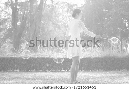 Asian women posing for pictures in white dresses in public parks relaxing beautiful bright light