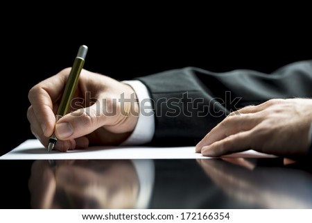 Businessman writing a letter, notes or correspondence or signing a document or agreement, close up view of his hand and the paper Royalty-Free Stock Photo #172166354