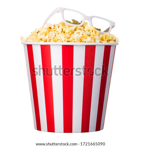 Paper striped bucket with popcorn and 3D glasses isolated on white background with clipping path. Concept of cinema or watching TV.