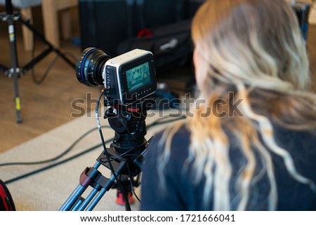 Professional video camera black magic 4k during set with female operator